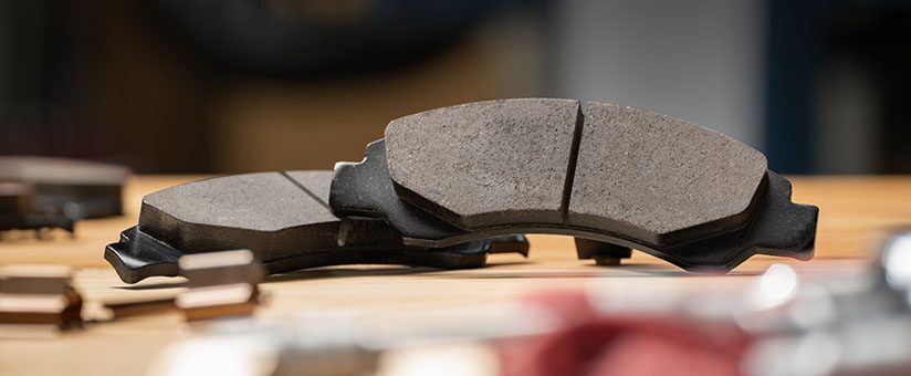 Closeup of Brake Pads Laying on Top of a Work Bench