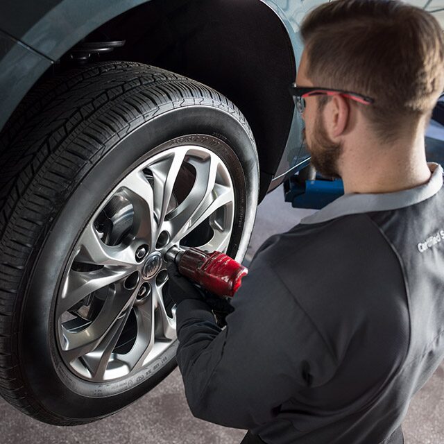 Buick Certified Service Technician Replacing Vehicle’s Tire