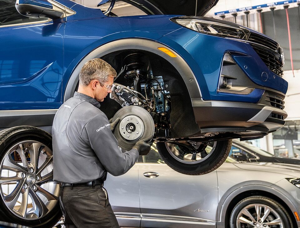 Certified Service Technician installing a brake rotor