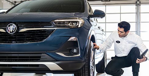 Closeup of a Technician Working on a Vehicle's Engine