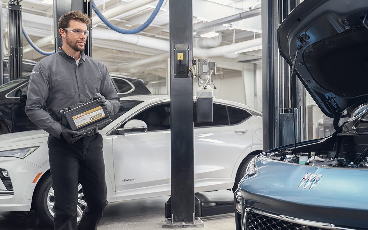 A Buick Certified Service Technician Installing a Battery