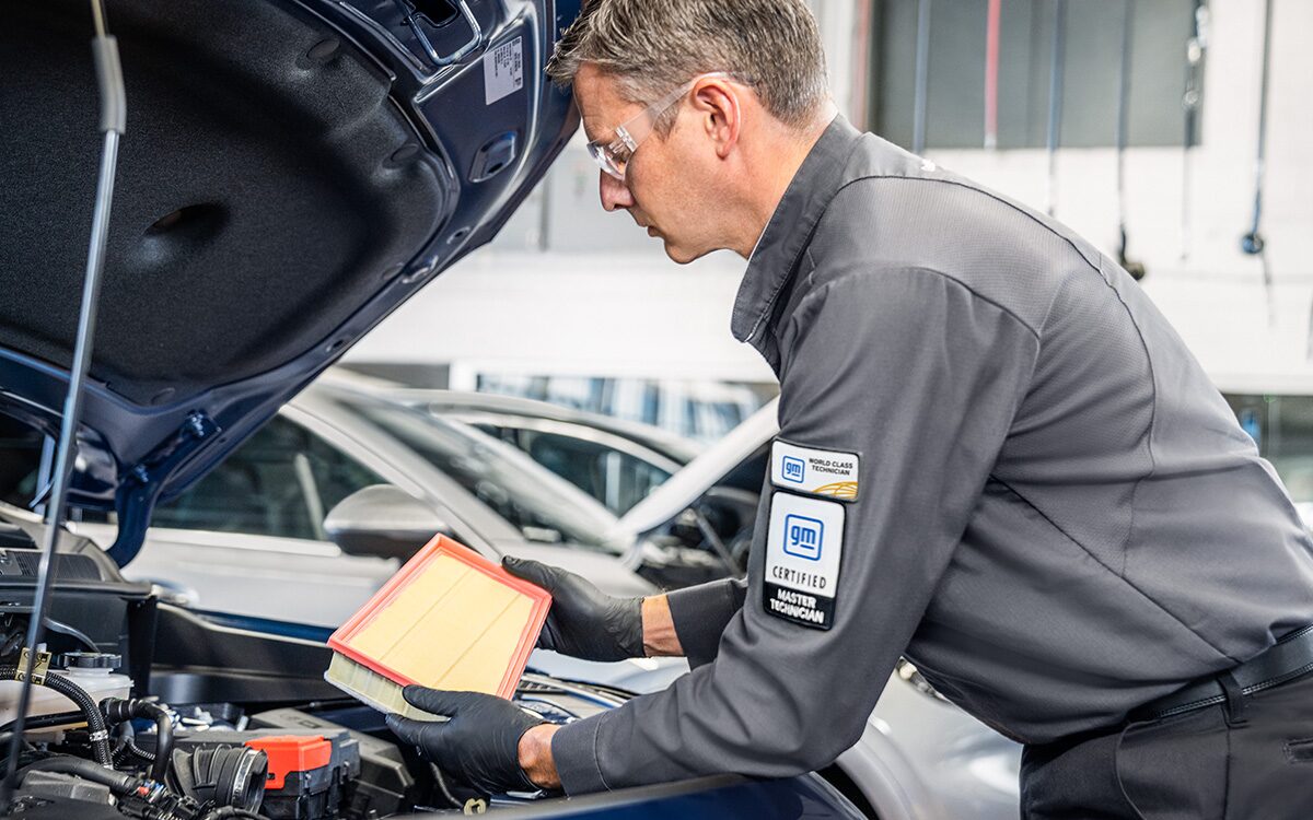 A Buick Certified Service Technician Installing an Engine Air Filter