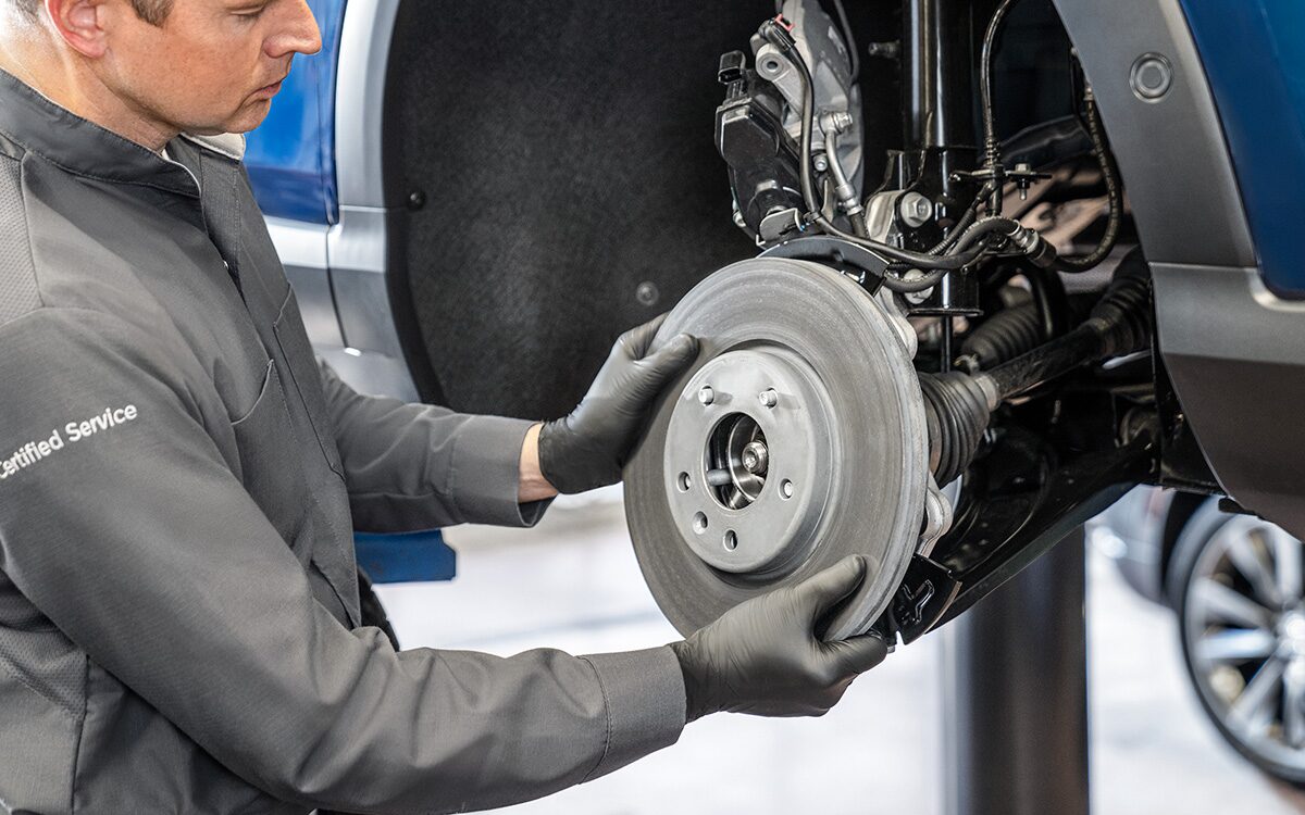Certified Service technician installing brake rotors