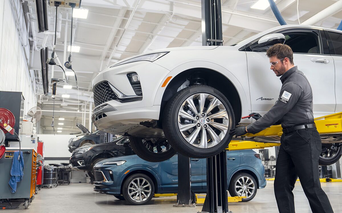 Certified Service technician performing a tire rotation on a vehicle
