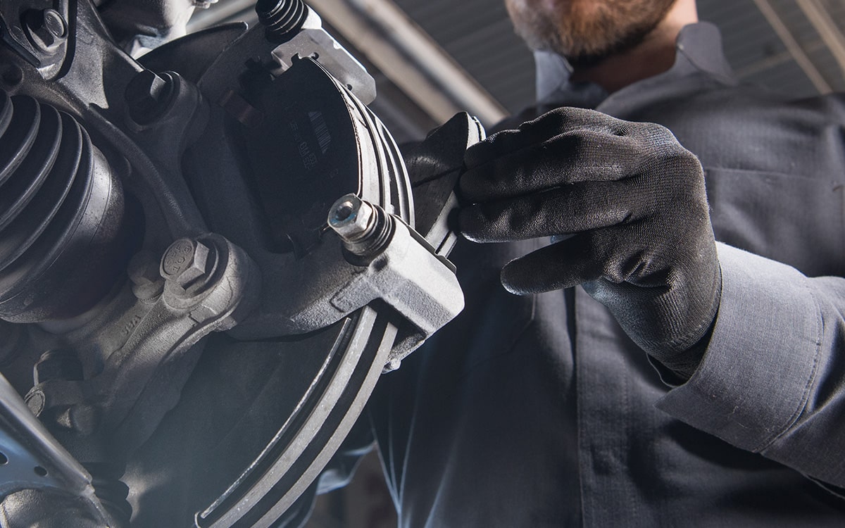 Certified Service technician performing a tire rotation on a vehicle