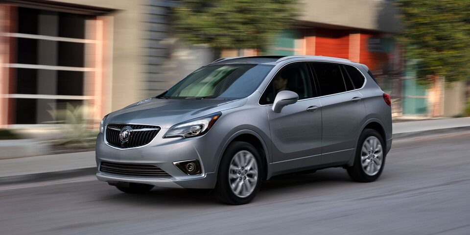 Buick Envision SUV drives on a city road