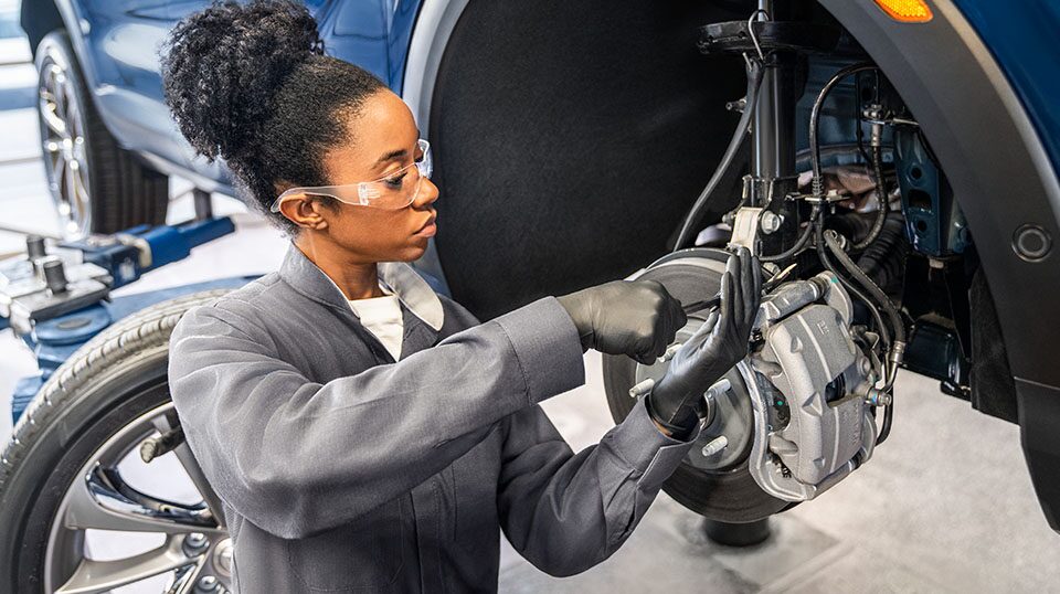 Buick Technician Mounting a New Tire on a Vehicle with Buick Logo and Text Overlay "Spring Tires and More Event"