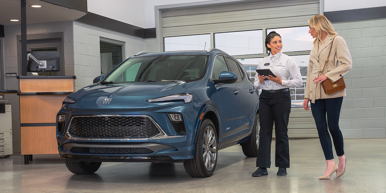 A Buick Dealers Employee Showing a Vehicle to a Customer