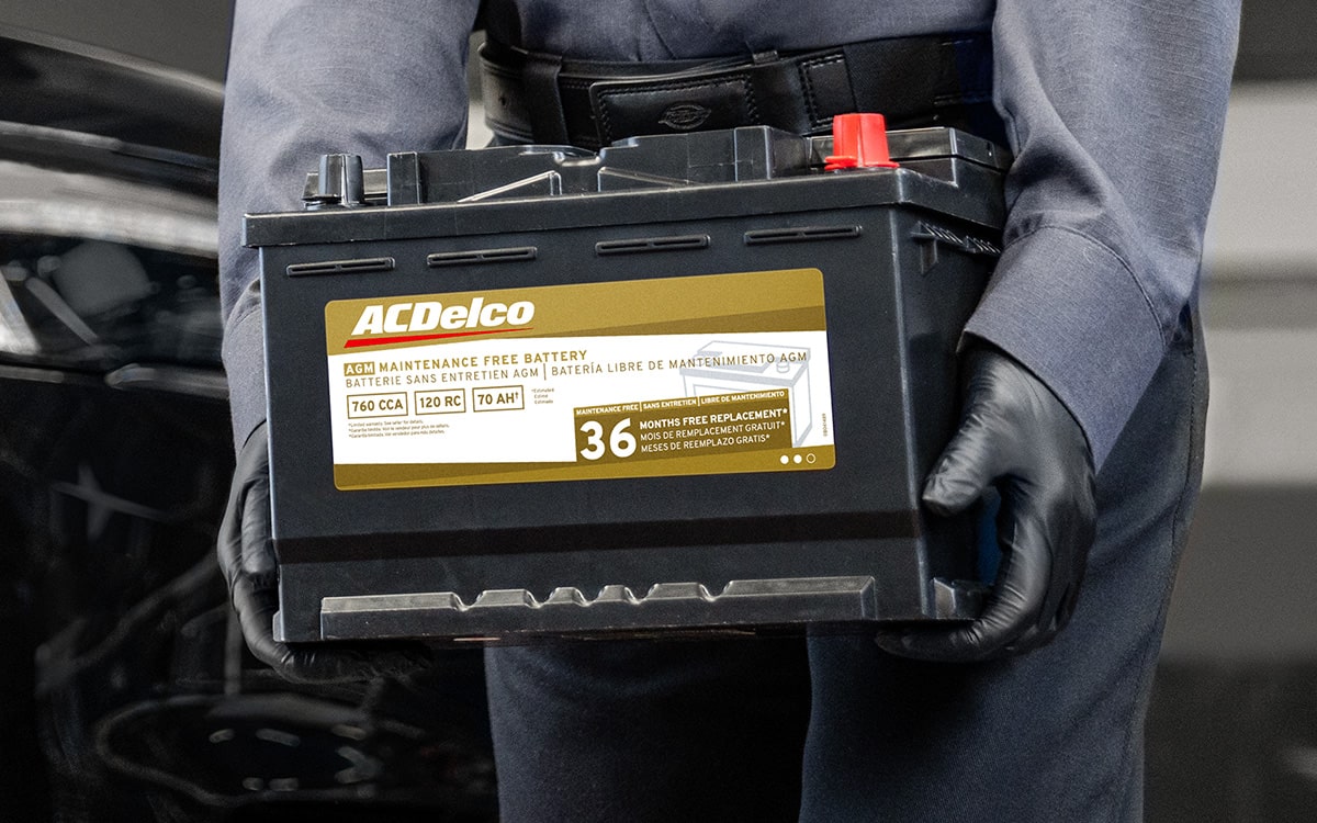 A Person Is Carrying and Walking with an Acdelco Battery