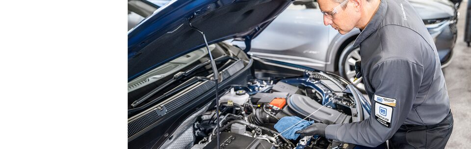 Buick Certified Service technician working under the hood of a vehicle