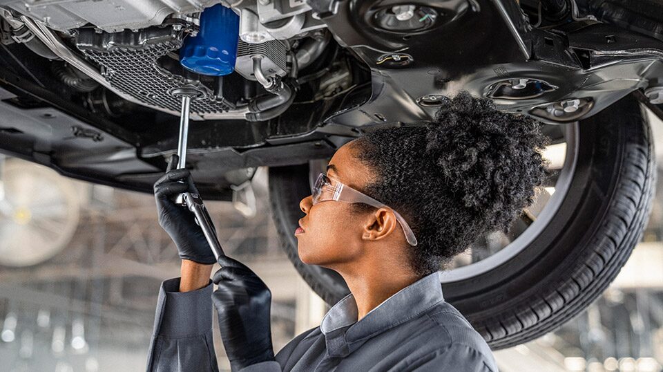 Buick Certified Service technician checking the oil of a vehicle