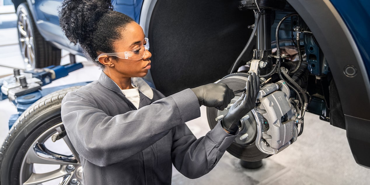 A Mechanic Is Working on the Wires of the Wheel of a Chevrolet Vehicle
