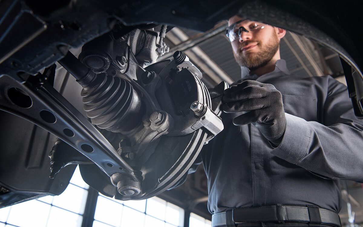 Certified Service technician installing brake pads