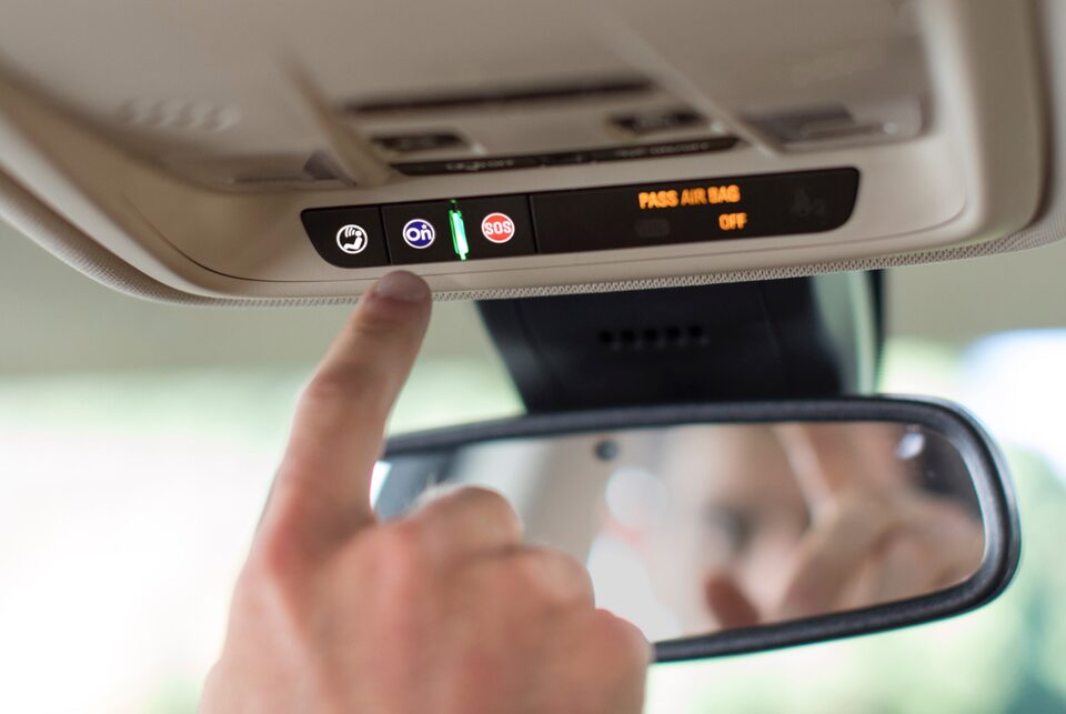 Image showing a man and a woman enjoying the hand free calling feature in a Buick vehicle.