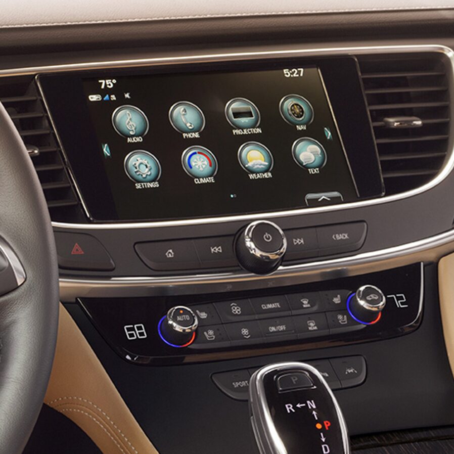Image of a woman using her smartphone to access the myBuick app and control key features of her Buick vehicle.