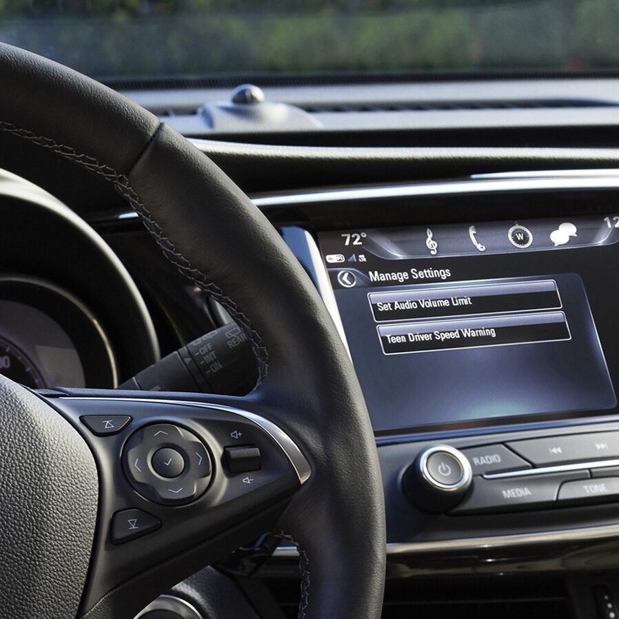 Image of a man using a tablet to access the convenient in-car Wi-Fi hotspot in his Buick vehicle.