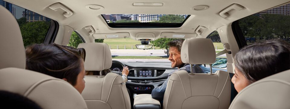 Medium View of Driver in Buick SUV Using SiriusXM