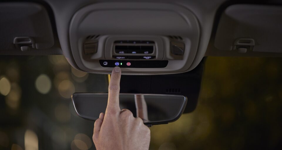 A Person Clicking the Buick OnStar Connectivity Button