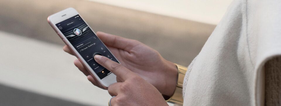 Person Wearing Bracelet Utilizing their Phone and the MyBuick App