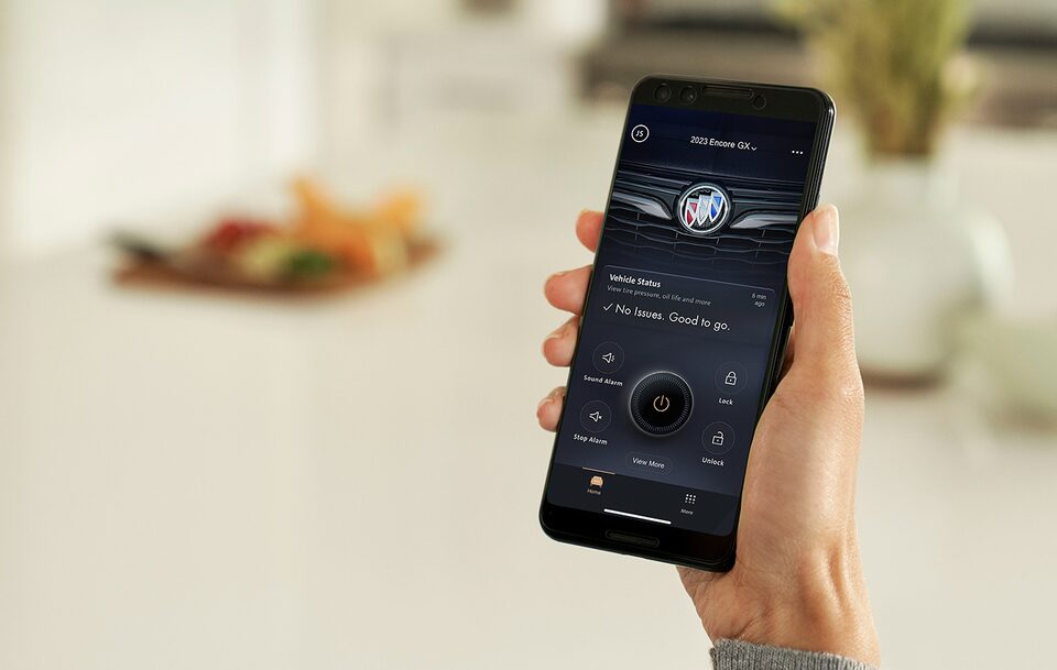 Person Holding a Smart Phone Displaying the MyBuick App Vehicle Status Update