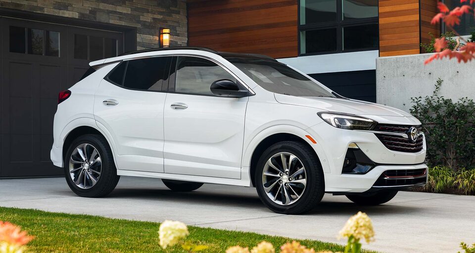 A Buick Encore GX ST Sport SUV Parked In-Front of a Luxurious Home