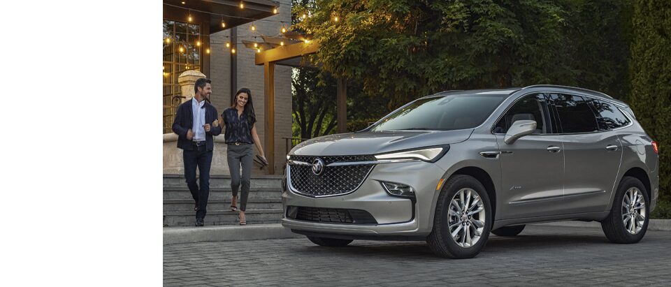 A Couple Approaches Their Parked Buick Enclave