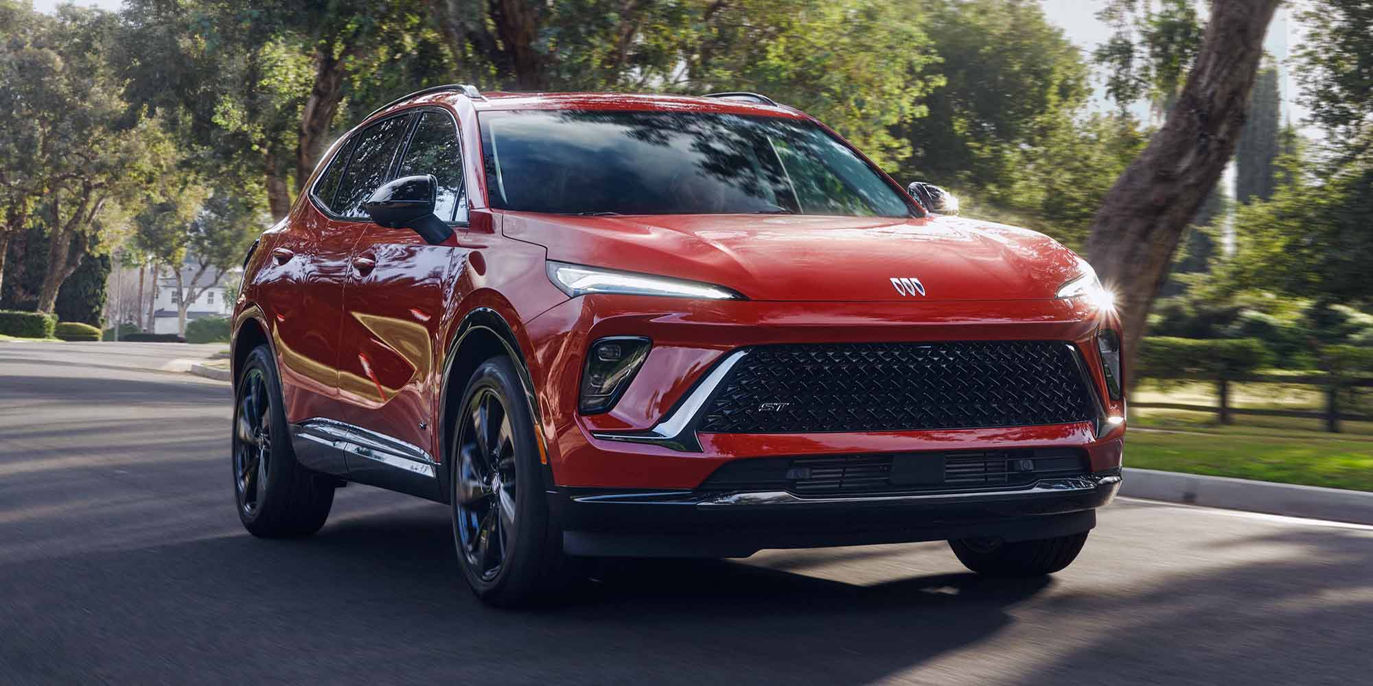 Front View of a Buick SUV Driving Through a Beautiful Green Park