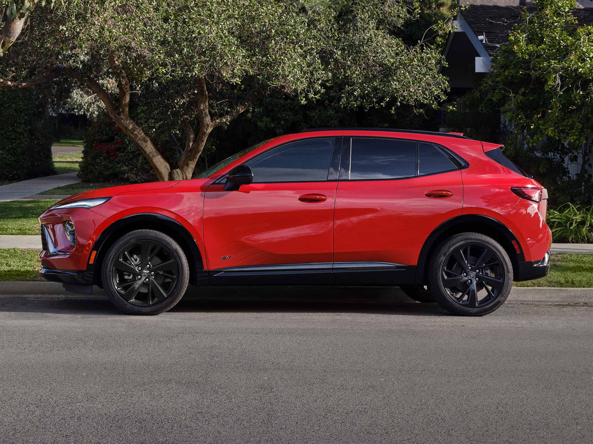 Profile View of a Red Buick SUV Parked on a Street Corner