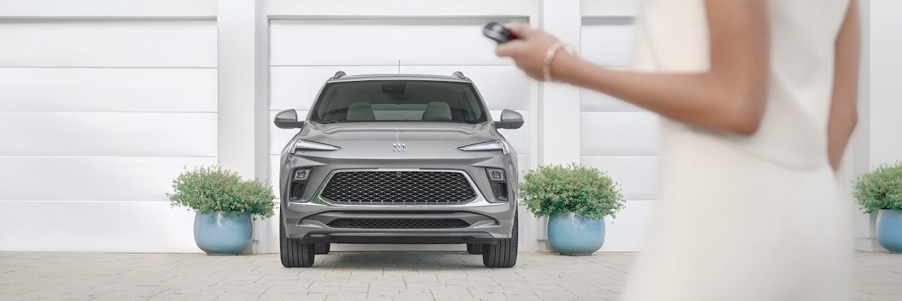 A Man in a Suit Driving a Buick Vehicle with a Modern Interior and Blue Accents