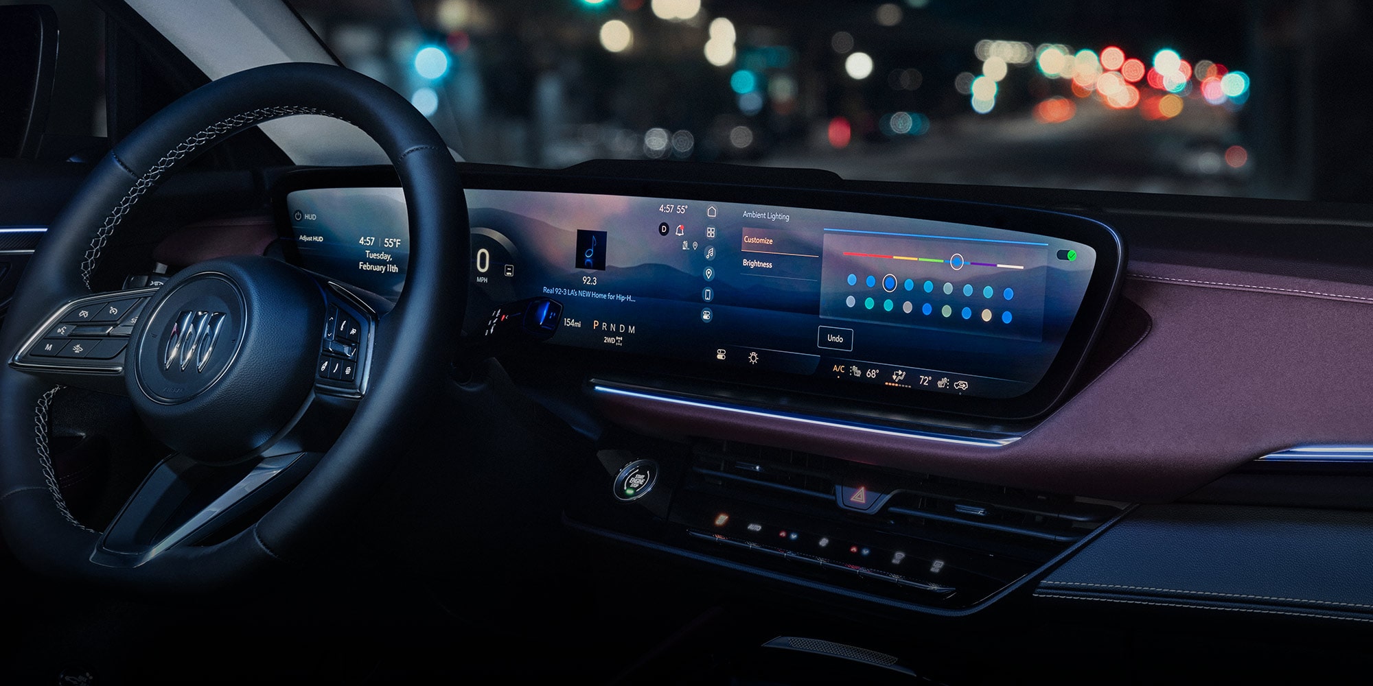 A Modern Interior View of a Buick Vehicle Featuring a Steering Wheel and Dual Digital Displays