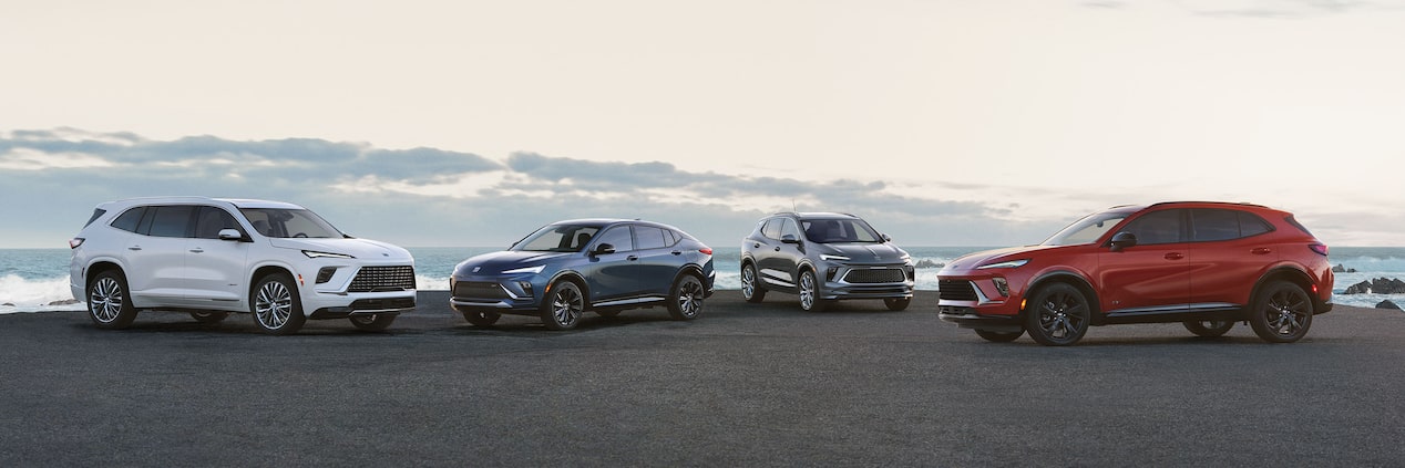 The 2025 Buick SUV Lineup Parked on a Beach at Sunset