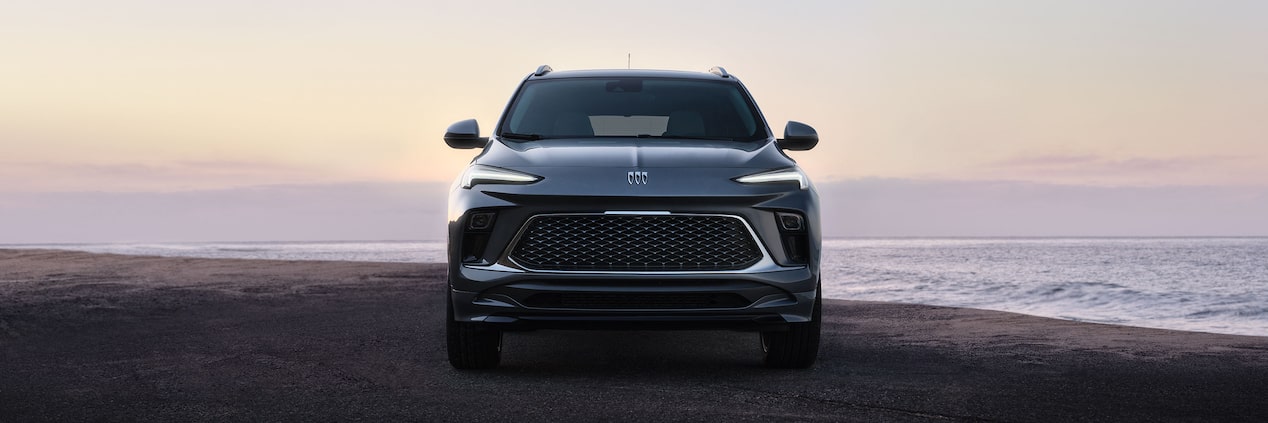 Front View of the Buick Encore GX Parked on a Beach at Sunset