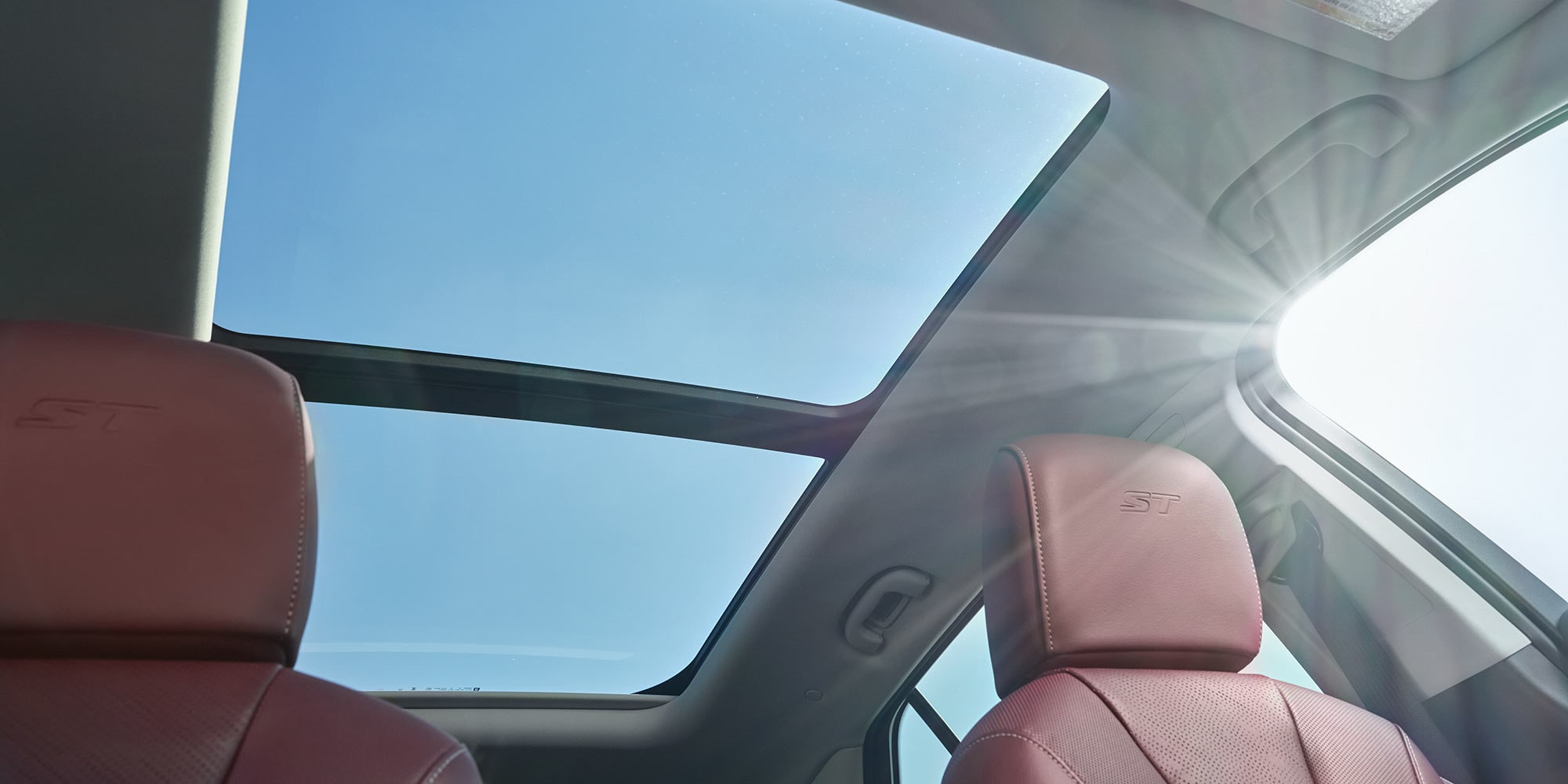 Interior View of the Panoramic Moonroof in the Buick Envision as the Sunlight Pours into the Vehicle