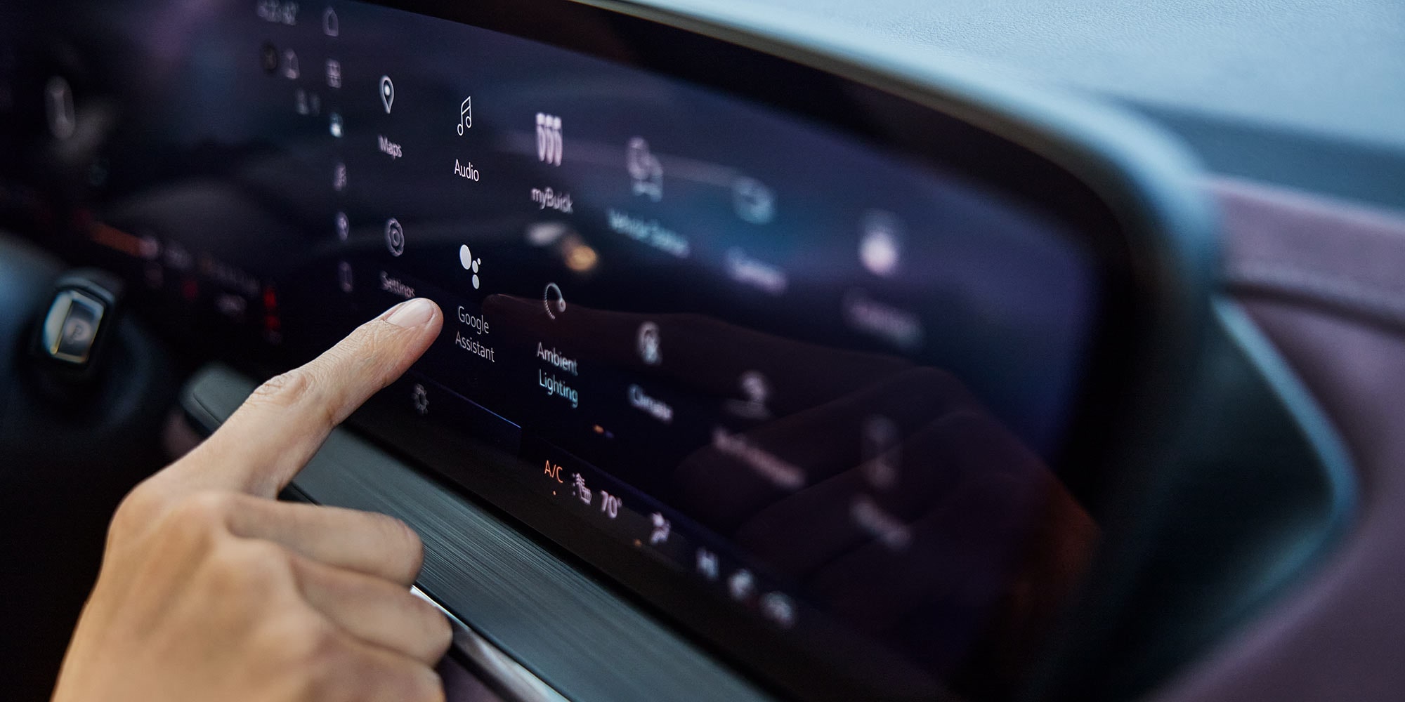 Close-up of the Driver in an Envision Using the Buick Infotainment Screen