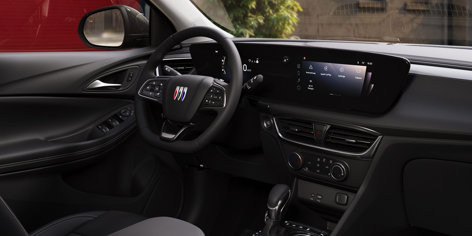 Three-quarters View of the 2026 Buick Envista Driving Out of the City Under a Street Light