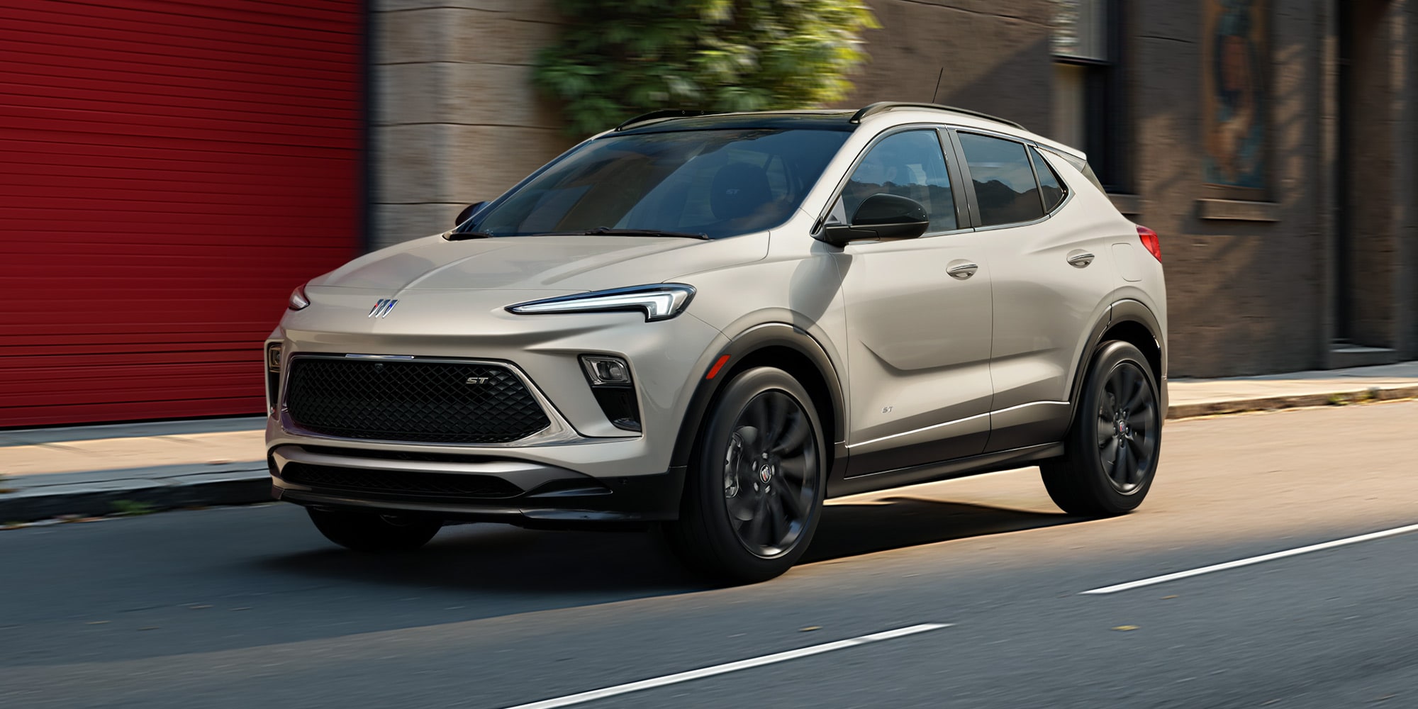 Three-quarters View of the 2026 Buick Envista Driving Out of the City Under a Street Light
