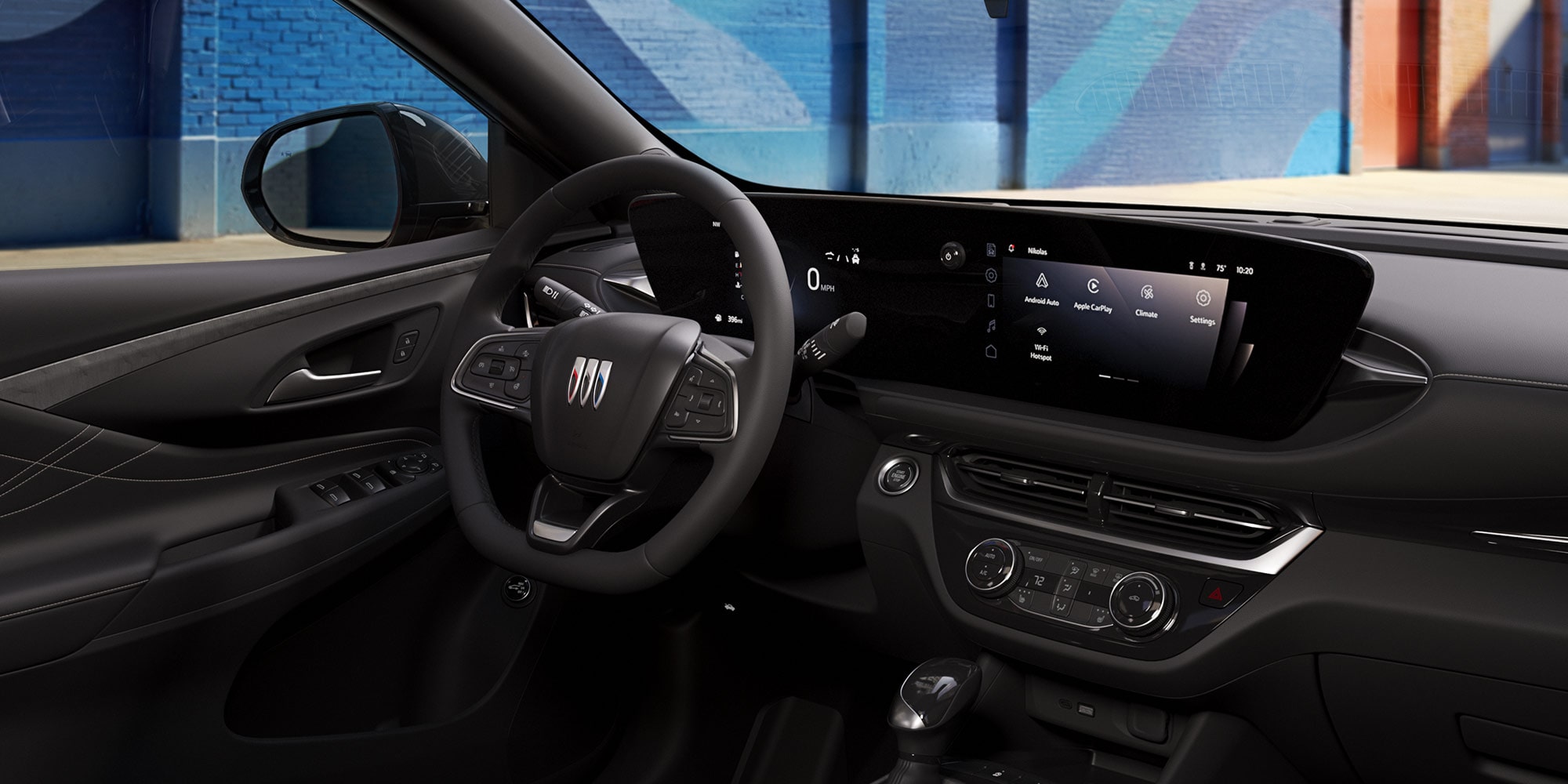 Three-quarters View of the 2026 Buick Envista Driving Out of the City Under a Street Light