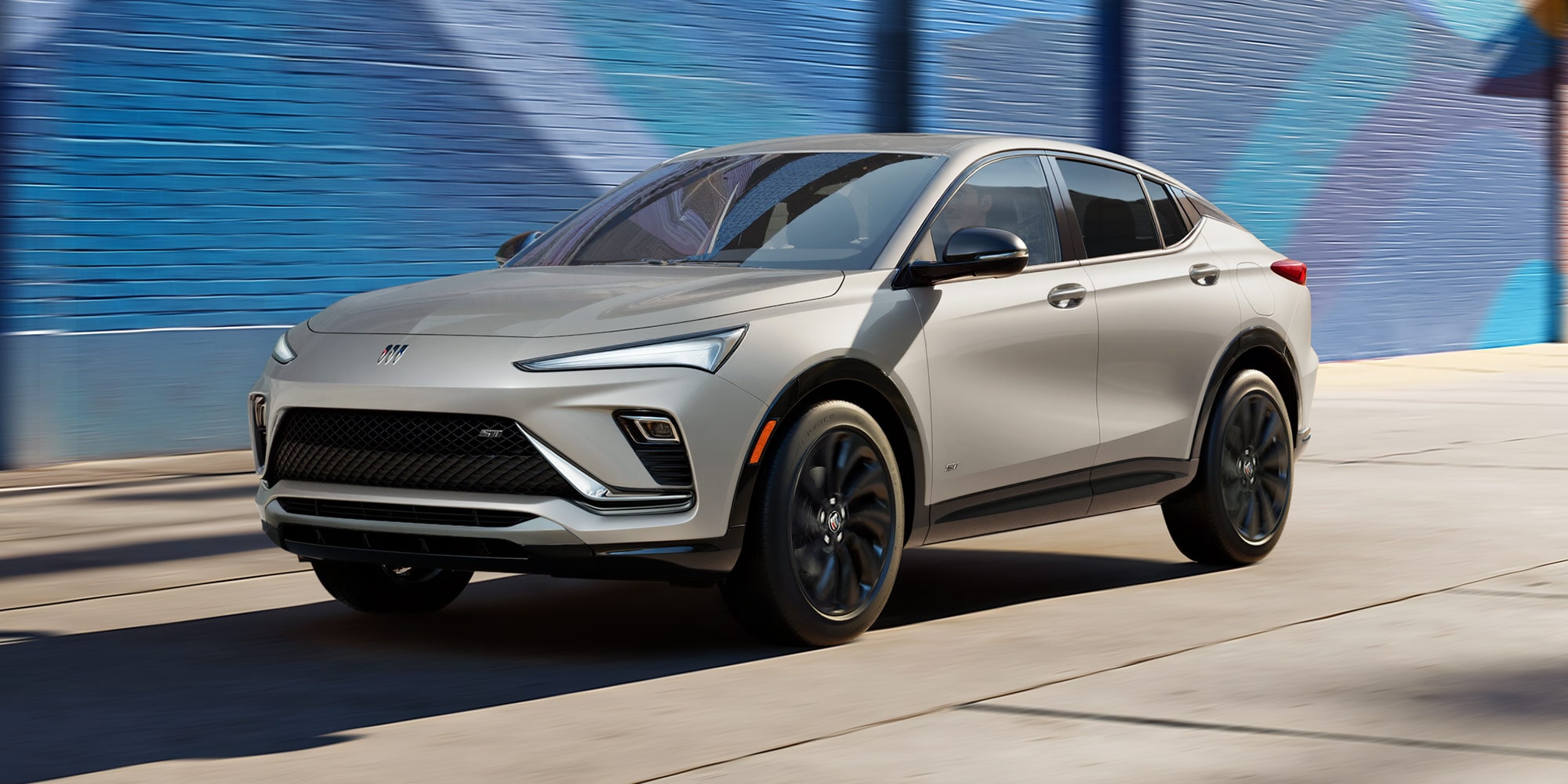 Three-quarters View of the 2026 Buick Envista Driving Out of the City Under a Street Light