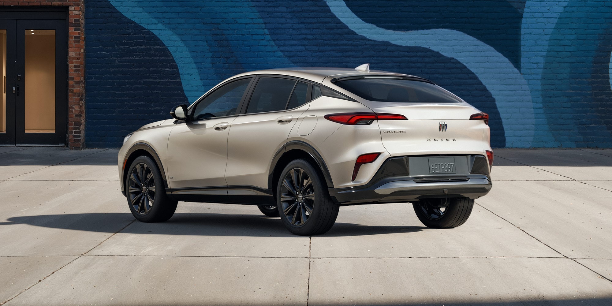 Three-quarters View of the 2026 Buick Envista Driving Out of the City Under a Street Light