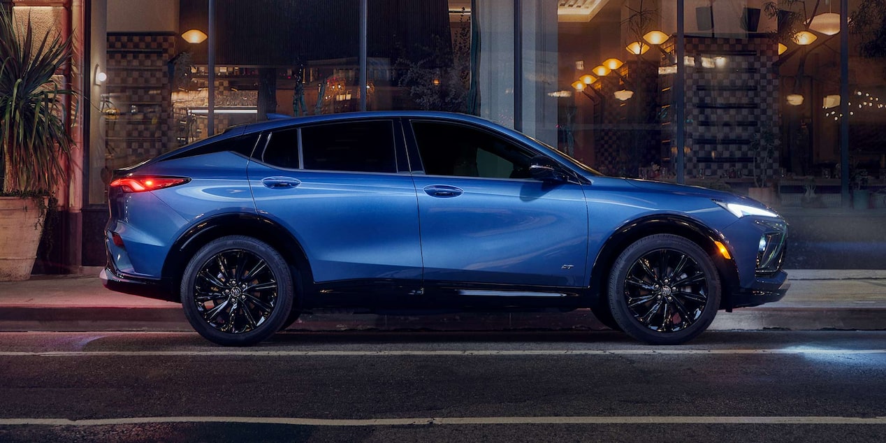 Profile View of the Buick Envista Compact SUV Parked on a City Street at Night