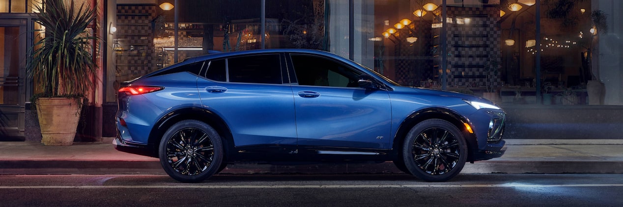 Profile View of the Buick Envista Compact SUV Parked on a City Street at Night