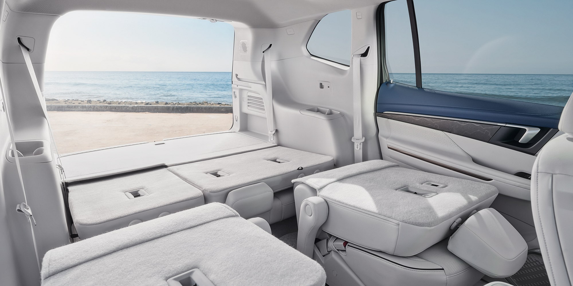 A Spacious Buick SUV Interior, with the Third-Row Seats Folded Flat for Maximum Cargo Capacity, Overlooks the Ocean