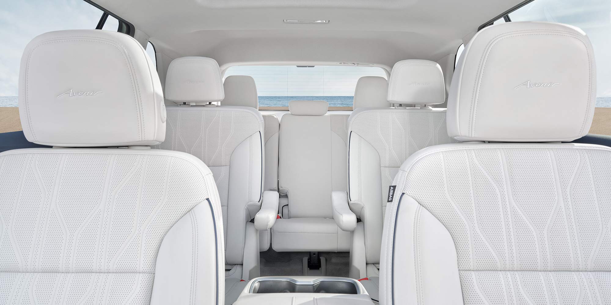 Interior View of the 3 Row Seating and the Avenir Embroidered Logo on the Front Row Head Restraints in the Buick SUV Avenir Trim