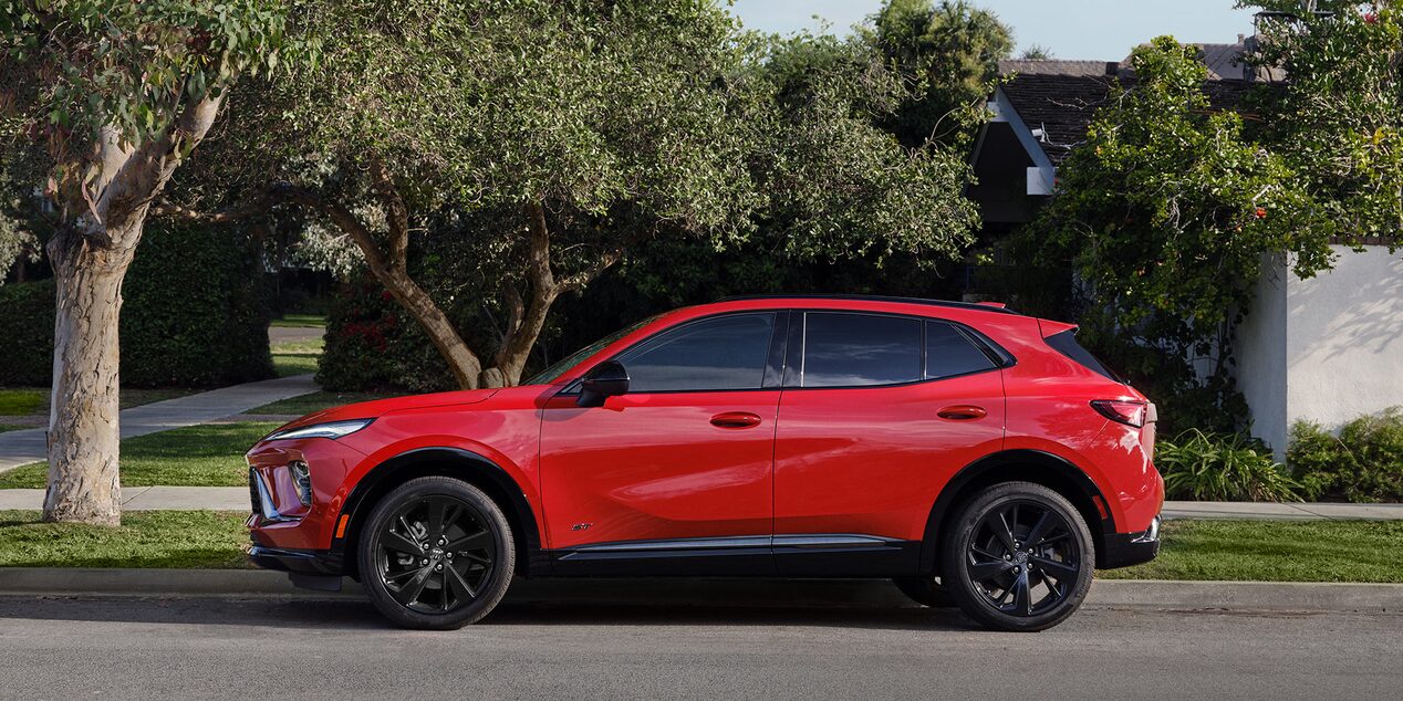 Red Buick Compact SUV Parked on a Residential Street with Trees and Houses