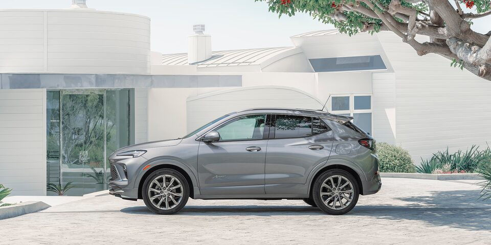 The Saphire Metallic Buick Encore GX Speeding Through a Neighborhood