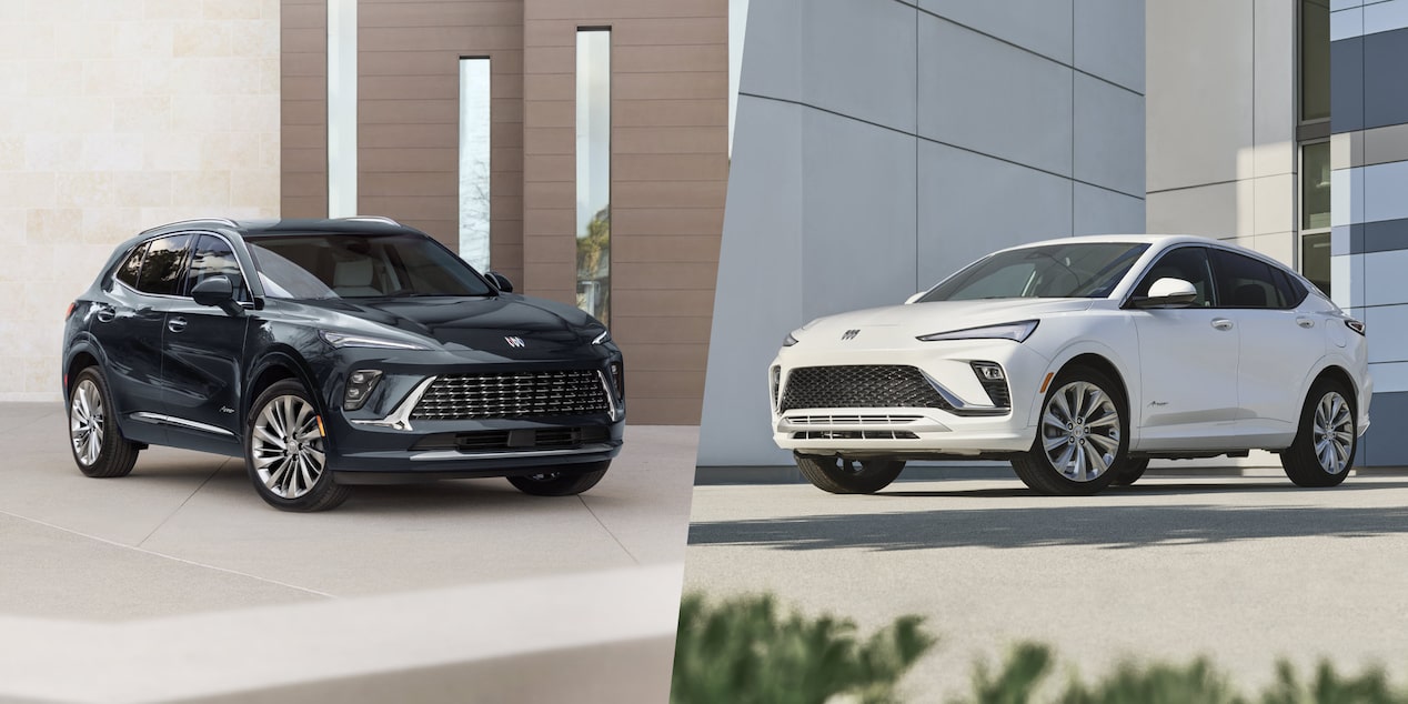  A Black Buick Envision and a White Buick Envista Parked Outdoors in Front of Modern Buildings
