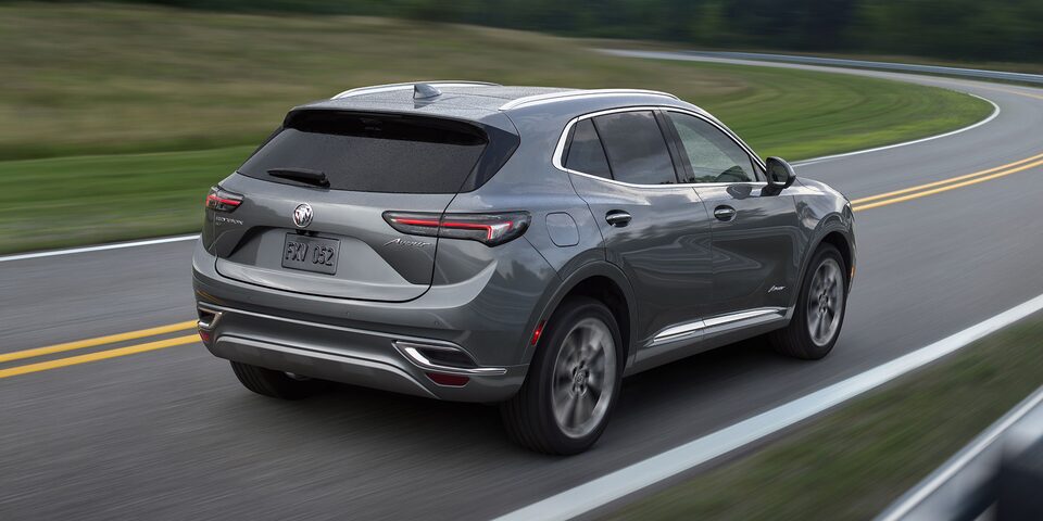 A Woman Drives Her Buick SUV on an Open Road