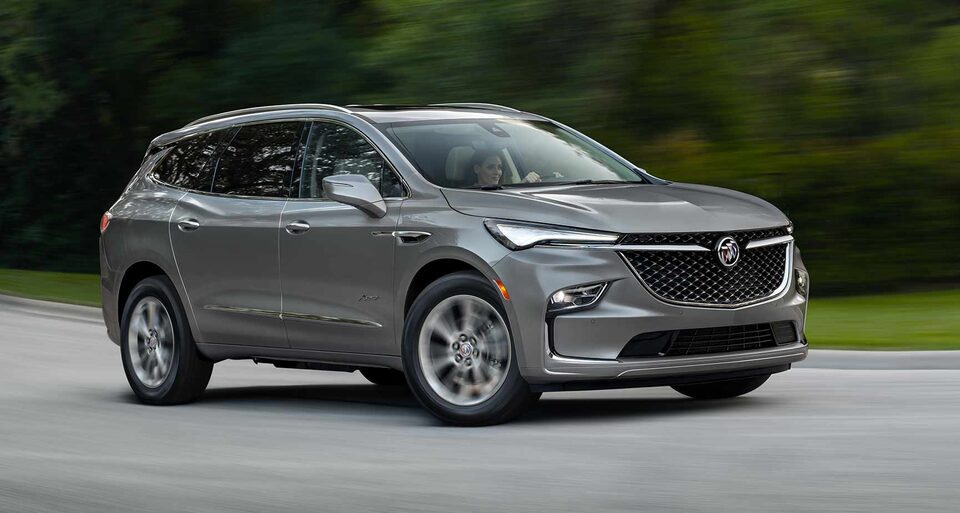A Woman Drives Her Buick SUV on an Open Road