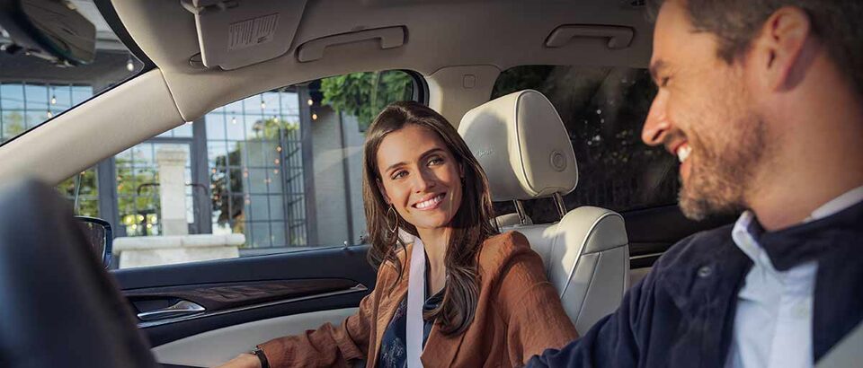 A Couple is in Good Spirits as they Enjoy Their Buick SUV