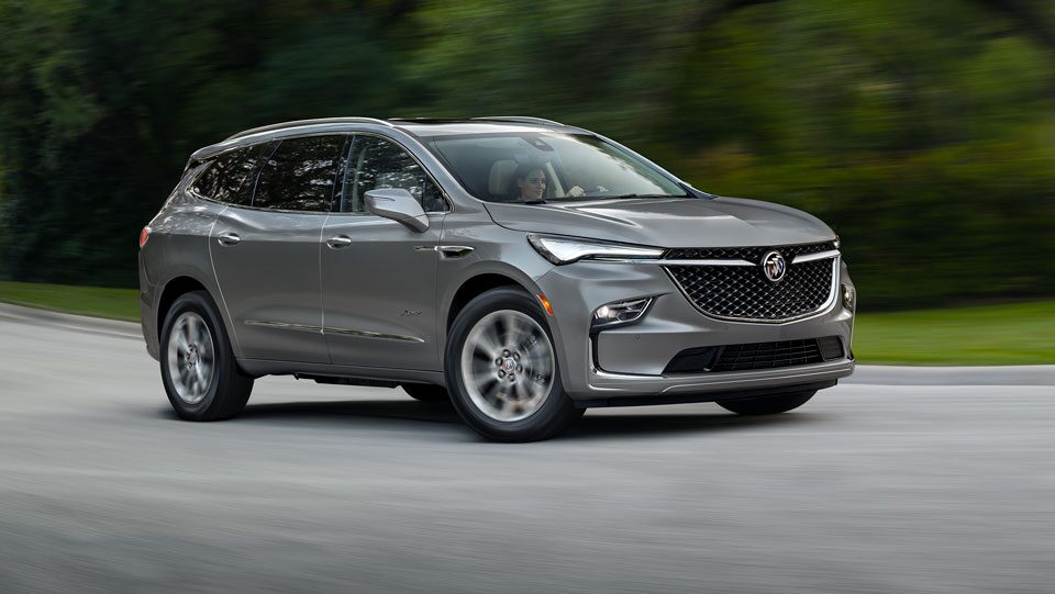 Buick SUV Driving on Empty Road Through the Trees